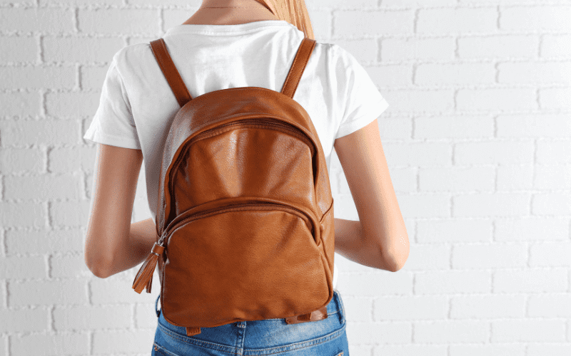 Image of a person with a stylish backpack. Focusing in the backpack.
