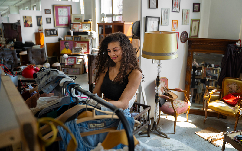 Image of a person happily browsing through a thrift store